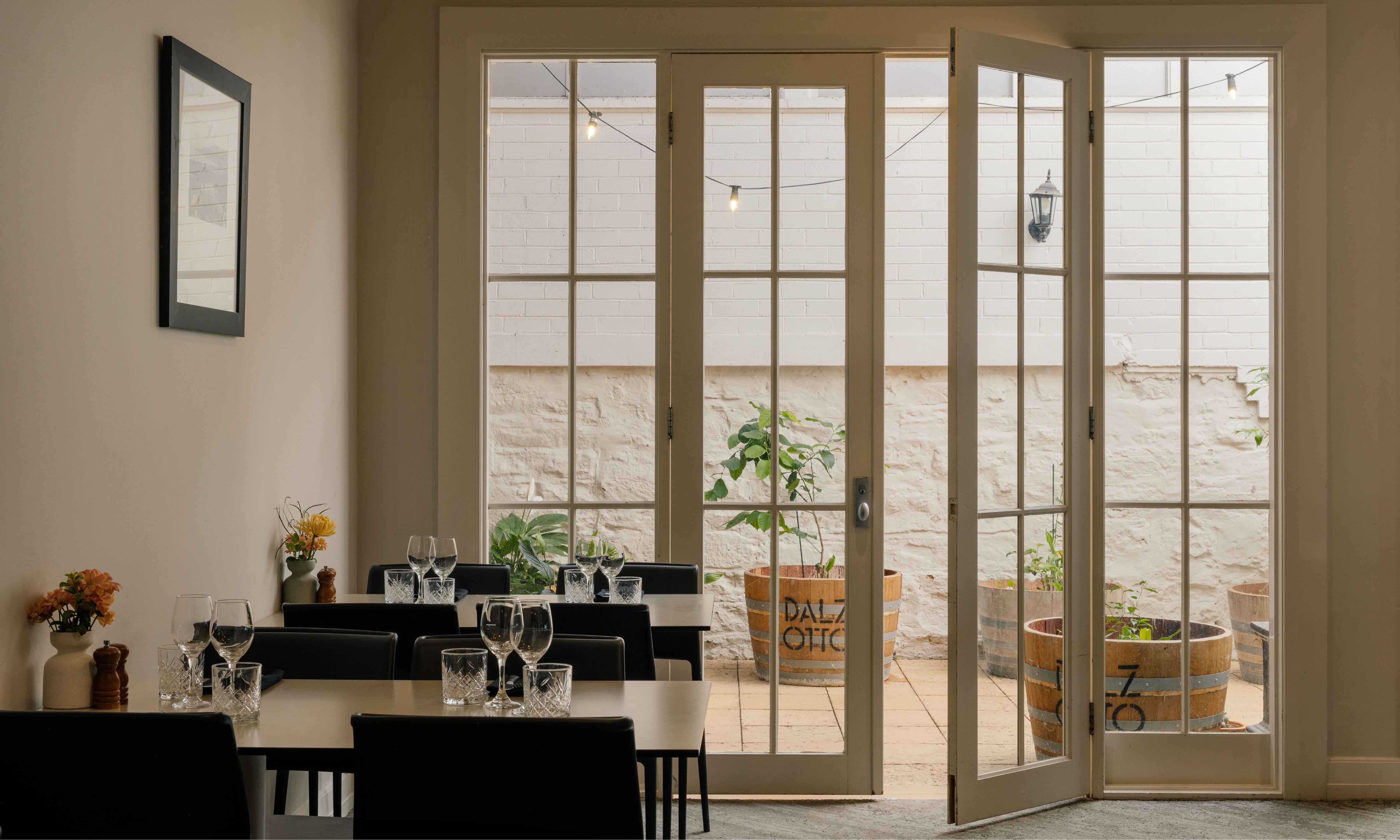 Dining tables in front of glass panelled doors